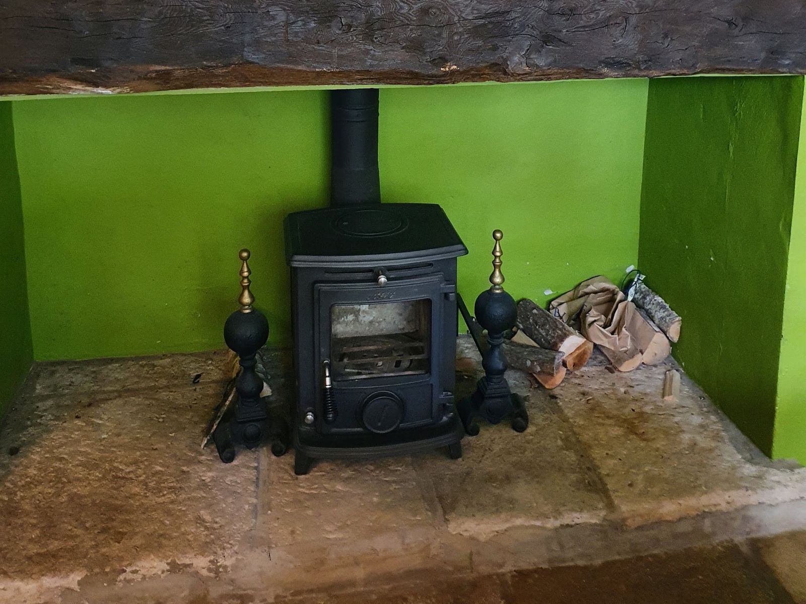 An Aga Wenlock stove against a green painted recess