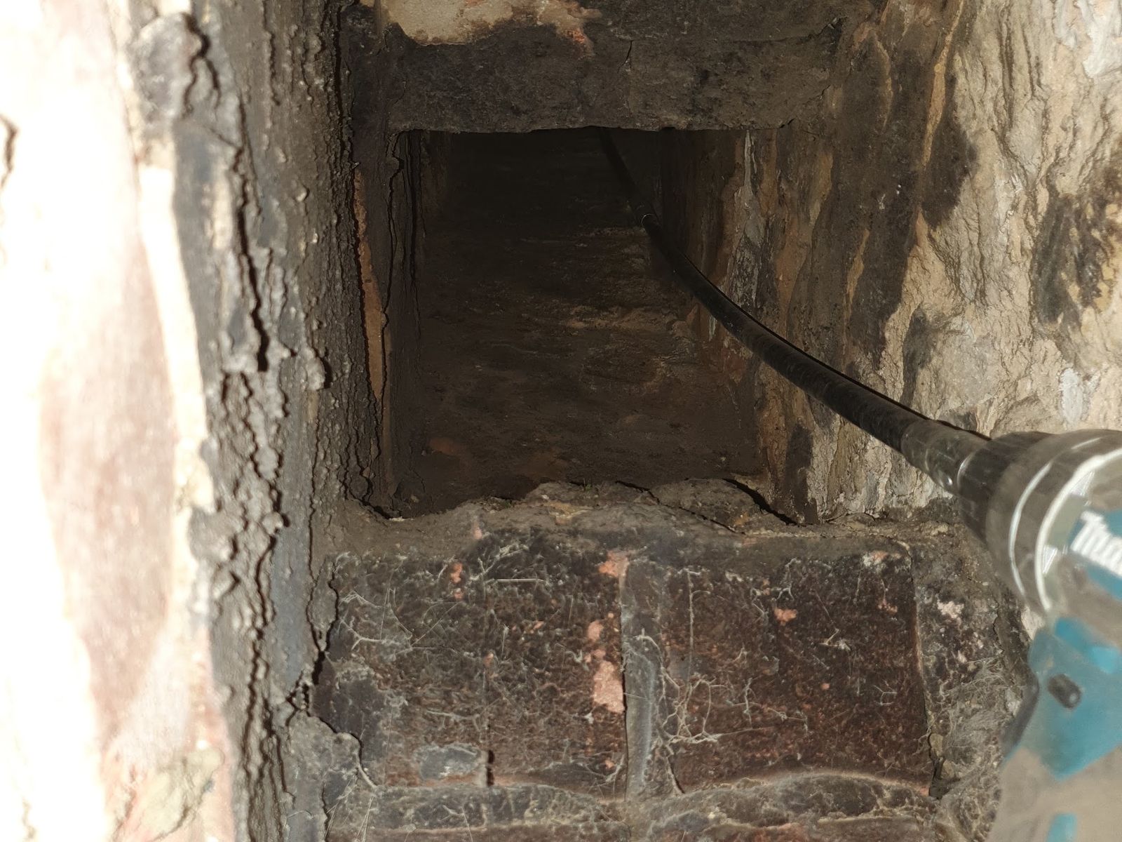 Looking into a chimney opening after a bird's nest was removed