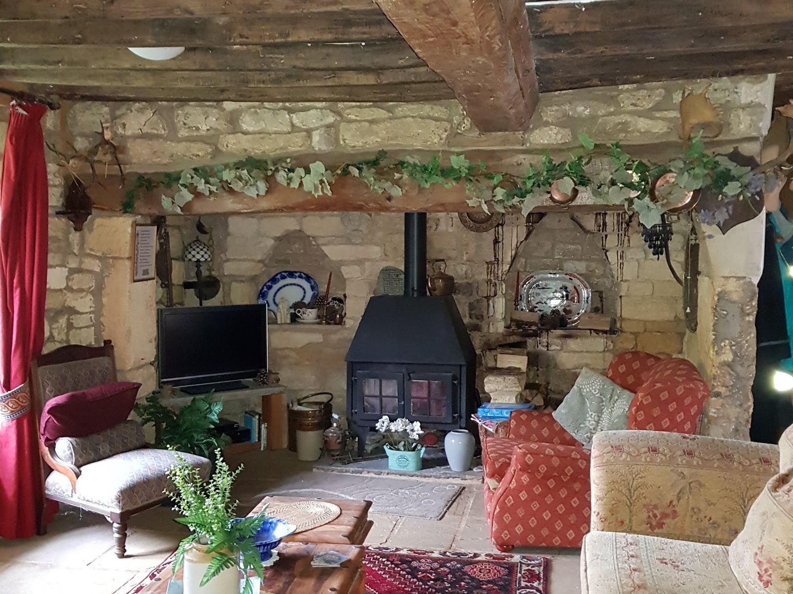 A great inglenook fireplace in a beamed cottage sitting room