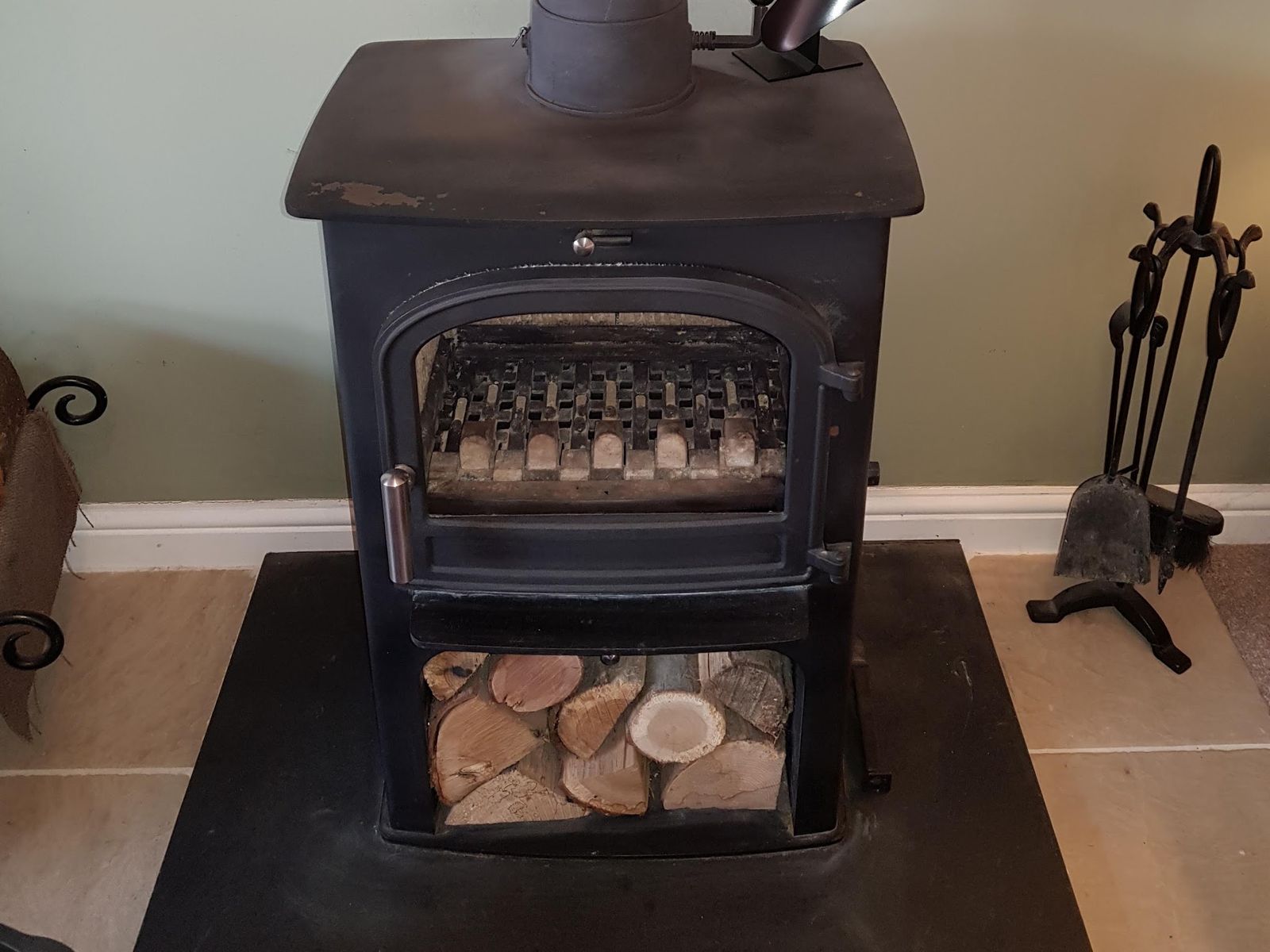 A Hunter stove with a log store below