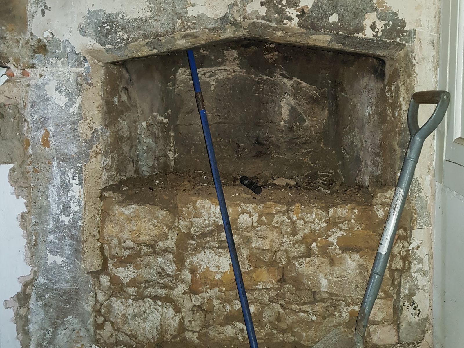 An old stone fireplace opening in a 16th century manor house