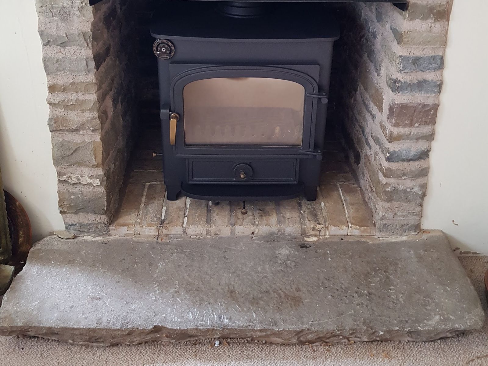 A Clearview Vision 500 sitting inside the fireplace after the flue exit was altered