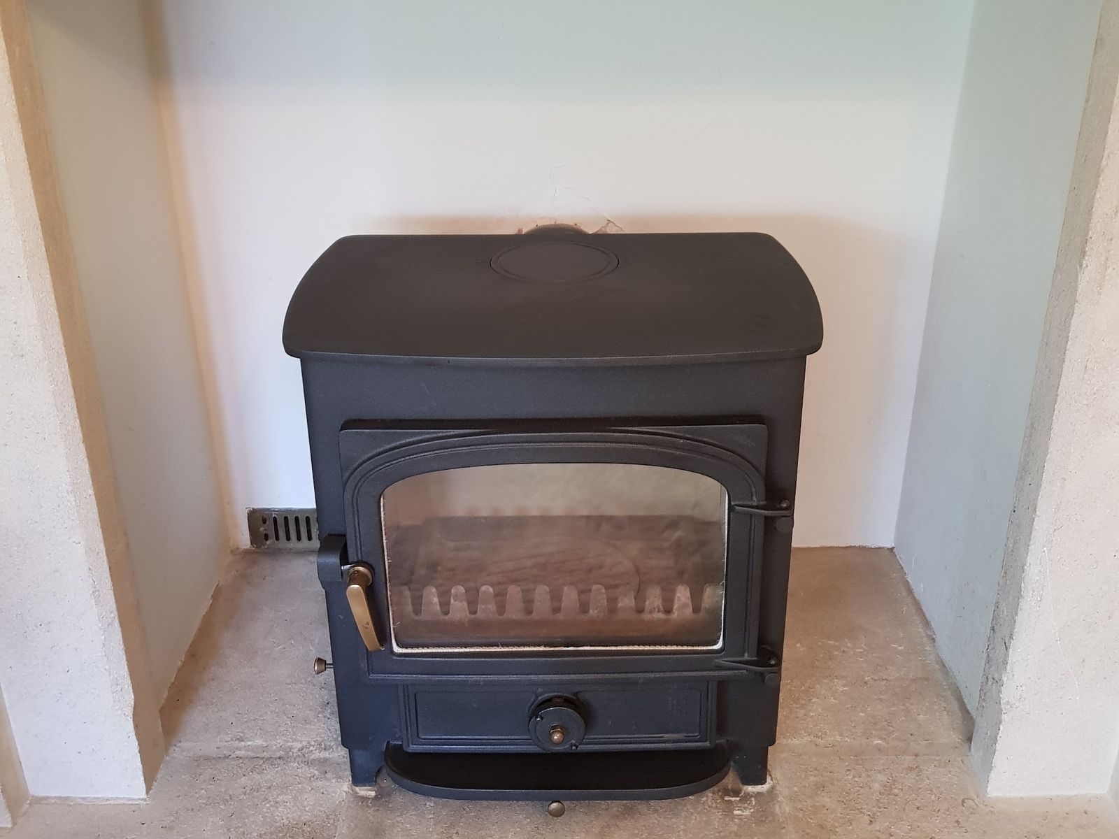 A Clearview Vision 500 after the old boiler was removed and the stove brick lined