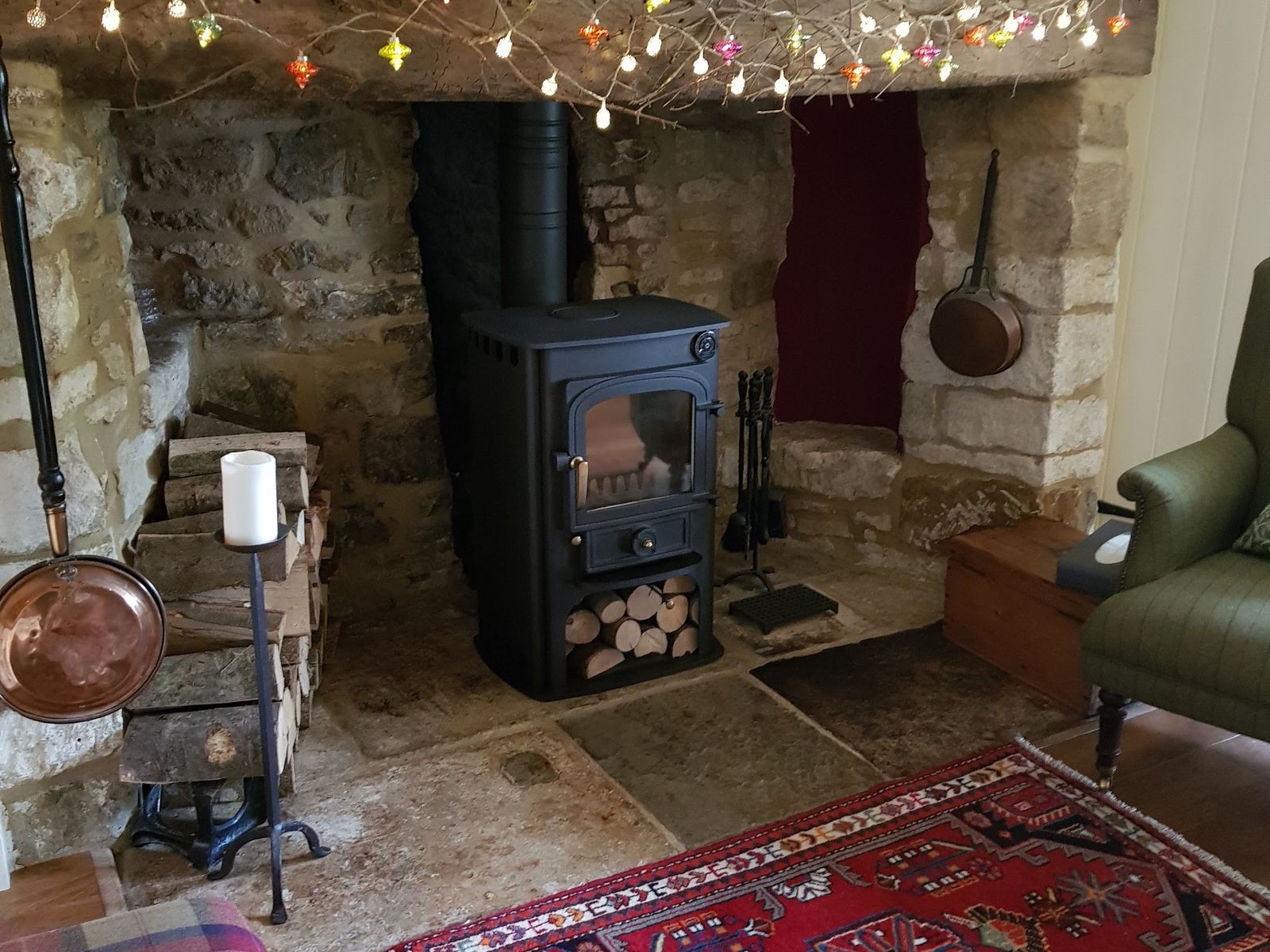 A Clearview Solution 400 in a stone inglenook with a rug